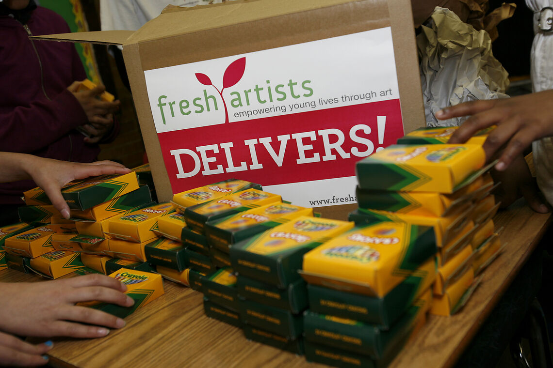 A table with boxes of food on it and a sign that says fresh artists deliver